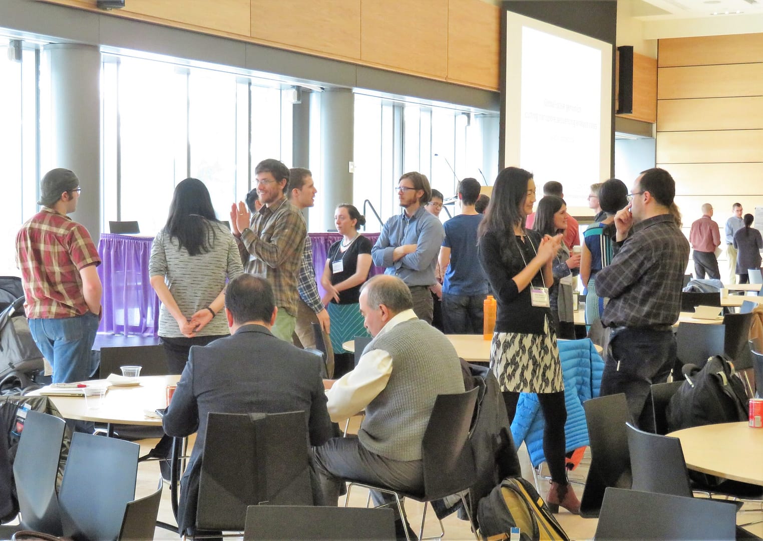 Participants chat in small groups at an event.