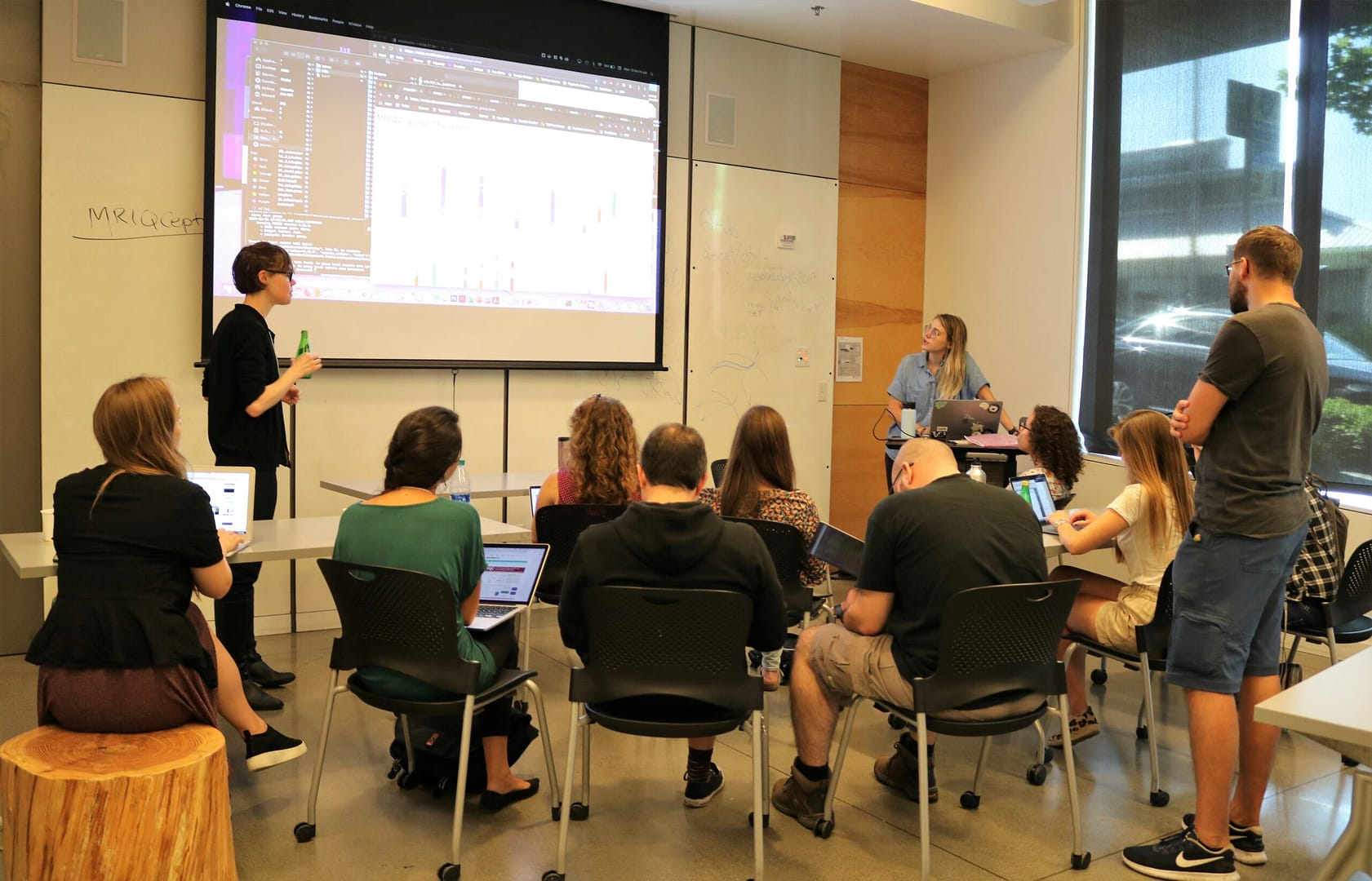 Neurohackademy participants watch a presentation