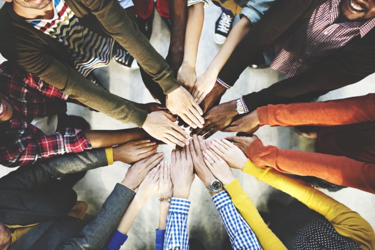 group of hands coming together